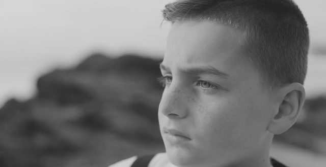 Still from Marloe: Remember Me (2022), directed by Michael S.U. Hudson: a young boy in profile, gazing into the distance