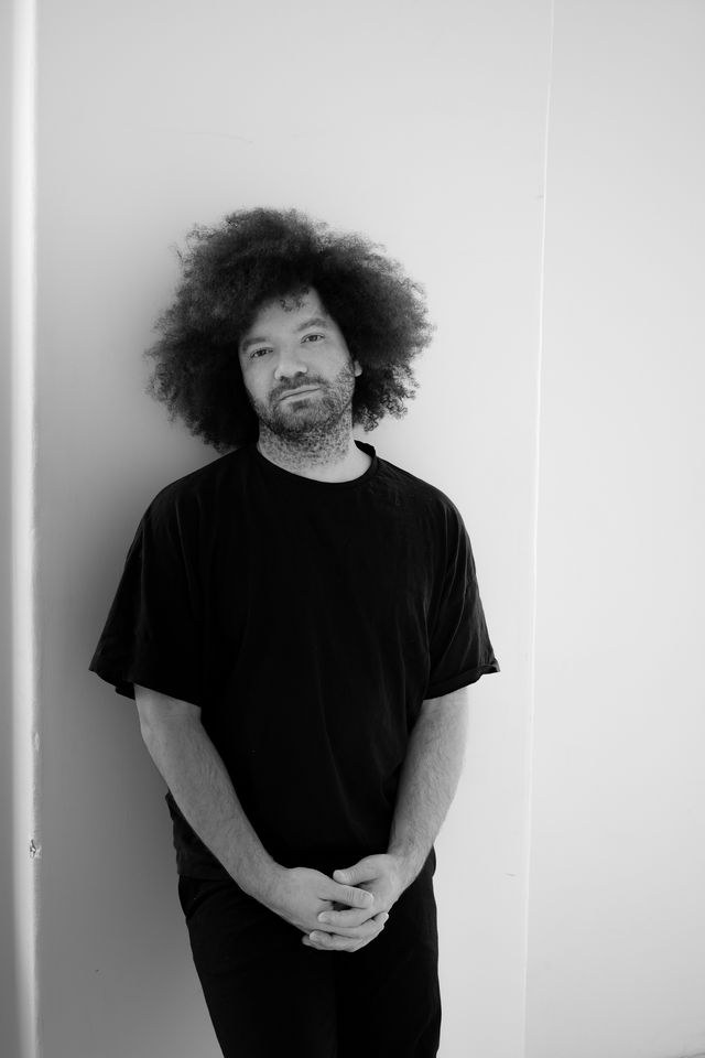 Michael S.U. Hudson, Creator, standing, full length, black and white